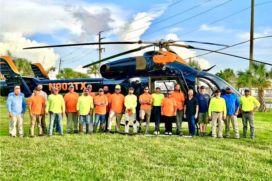 Gordon team beside helicopter